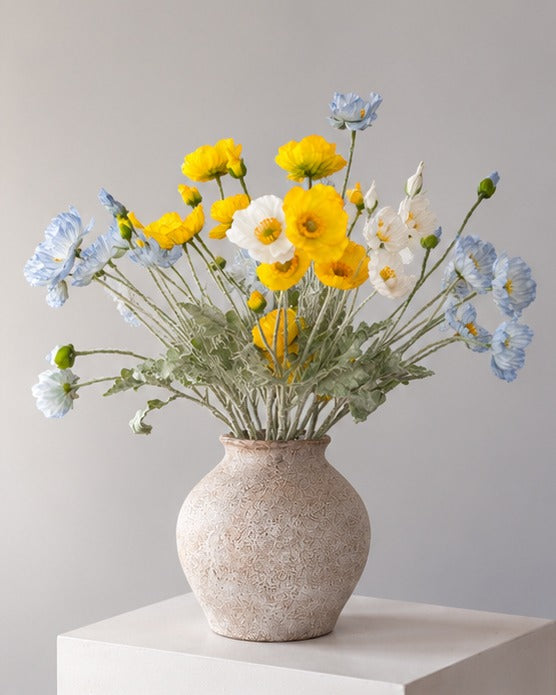 Sunny Days: loose poppy stems spilling over the stone vase