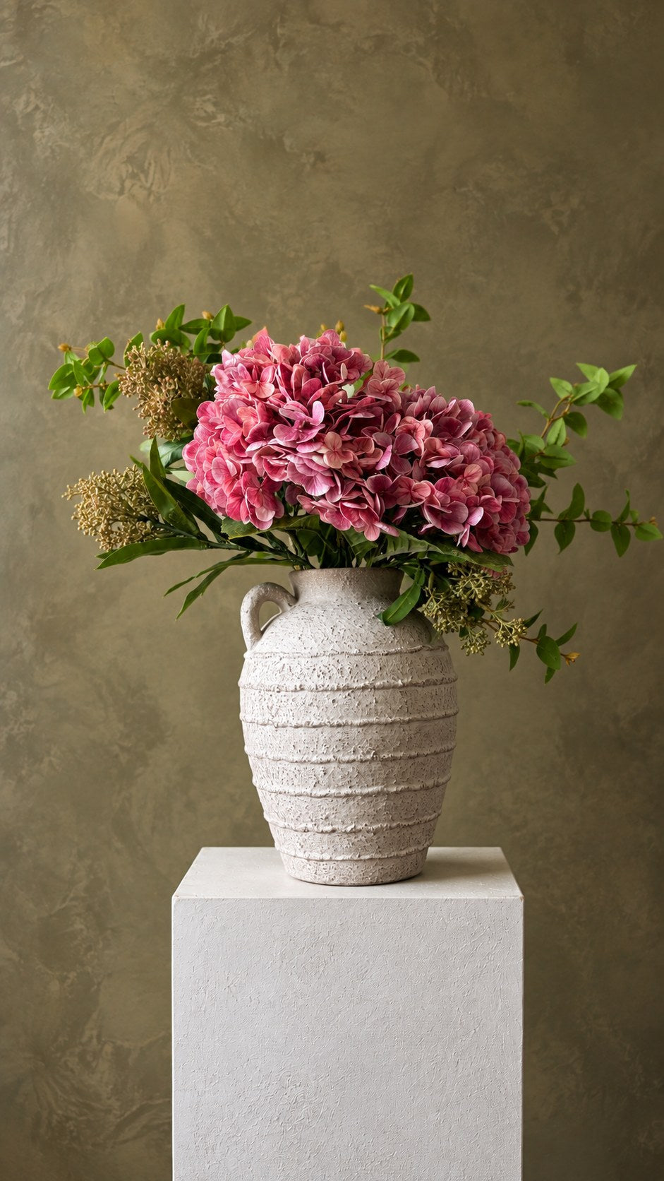The Entryway: rose hydrangea with greenery in a stone jug on a white plinth